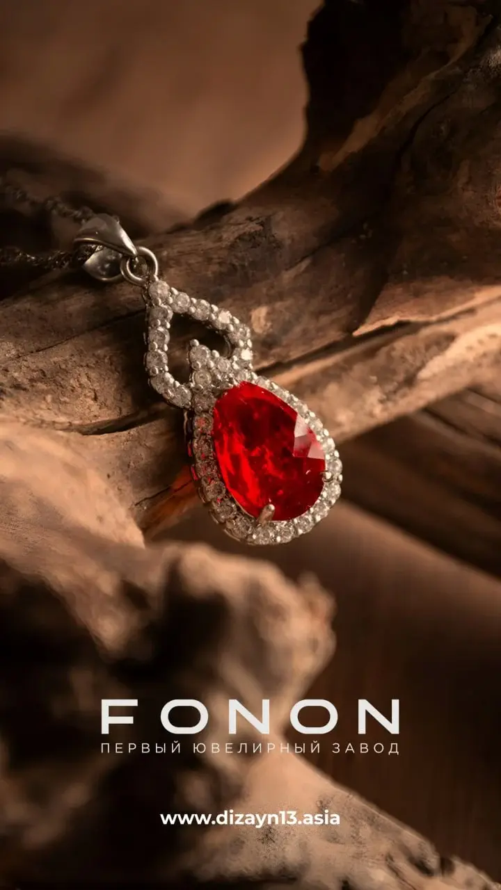 Ruby pendant resting on weathered driftwood