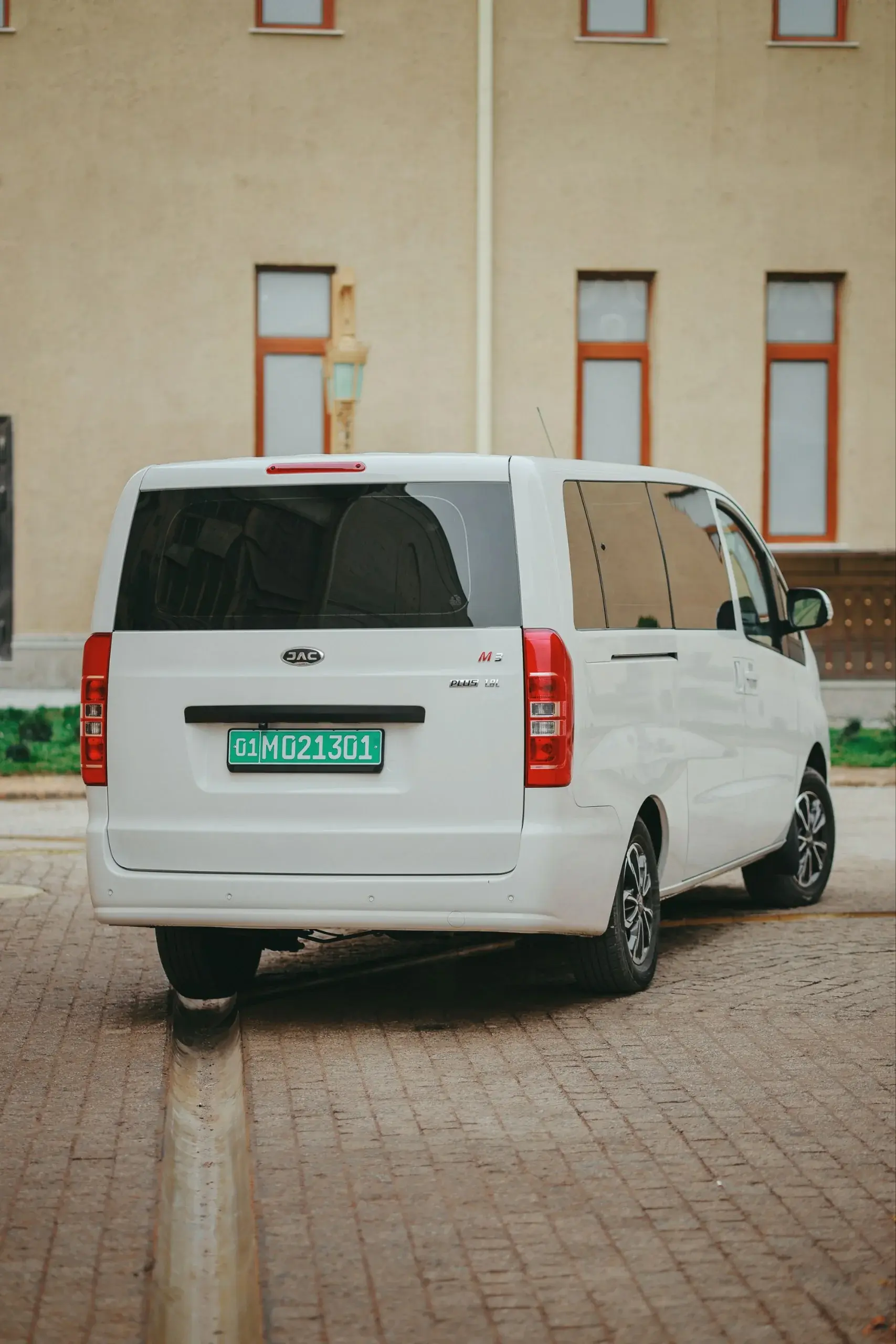 Rear three-quarter view of the M3 Plus minivan on a cobbled courtyard