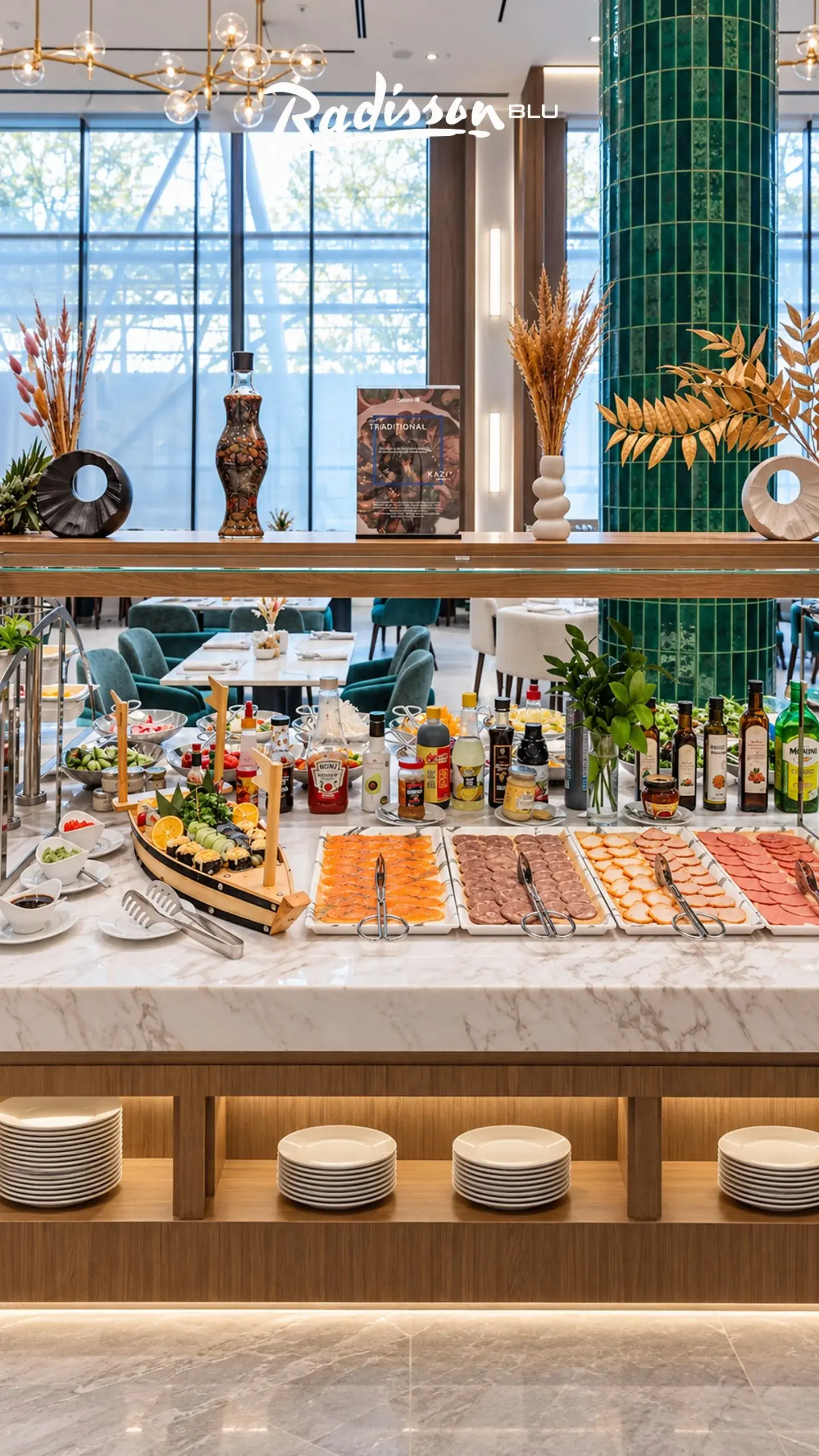 Breakfast buffet with sushi boat and cold cuts on a marble counter