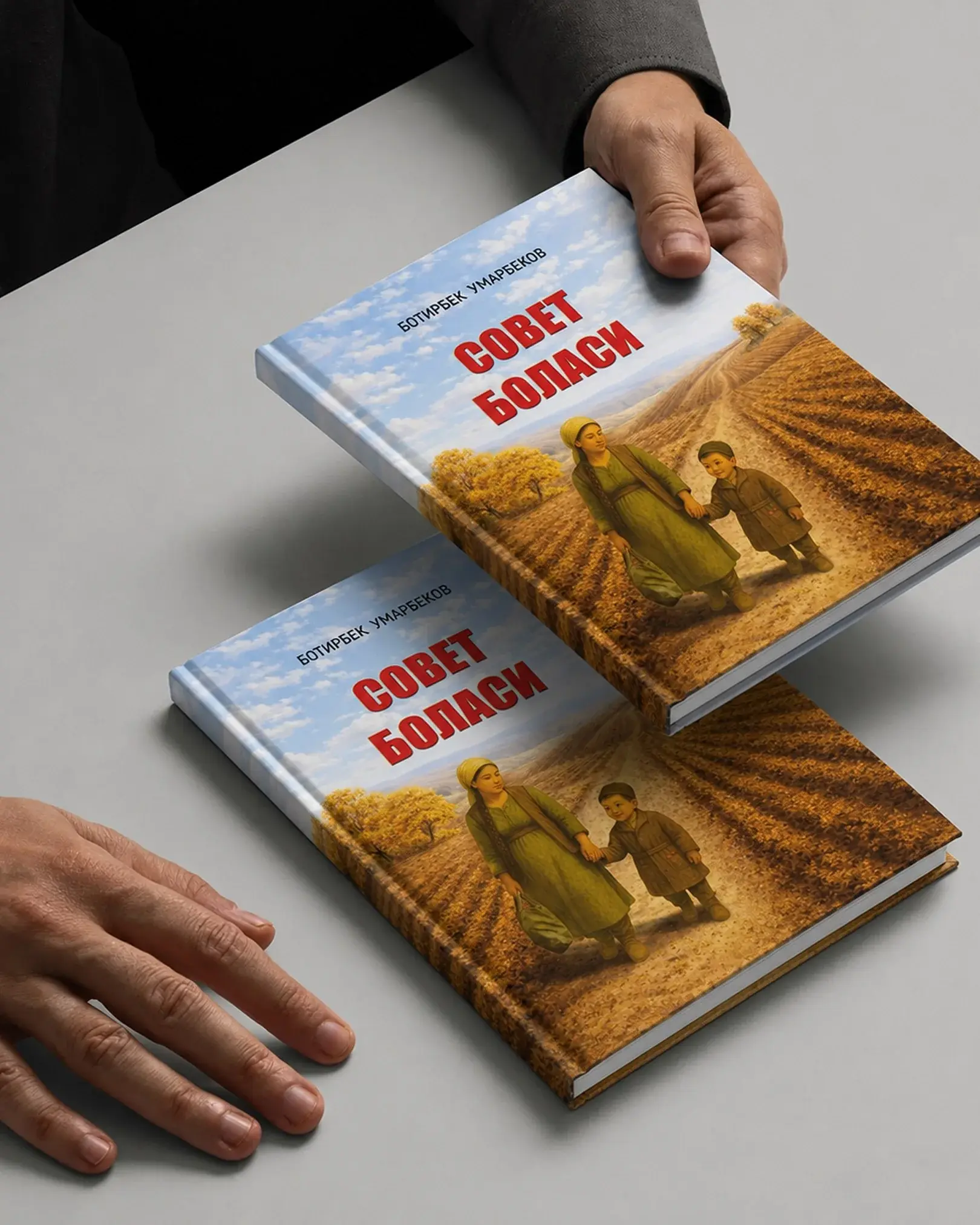 Two hardcover copies of Sovet bolasi with the painted field-road cover
